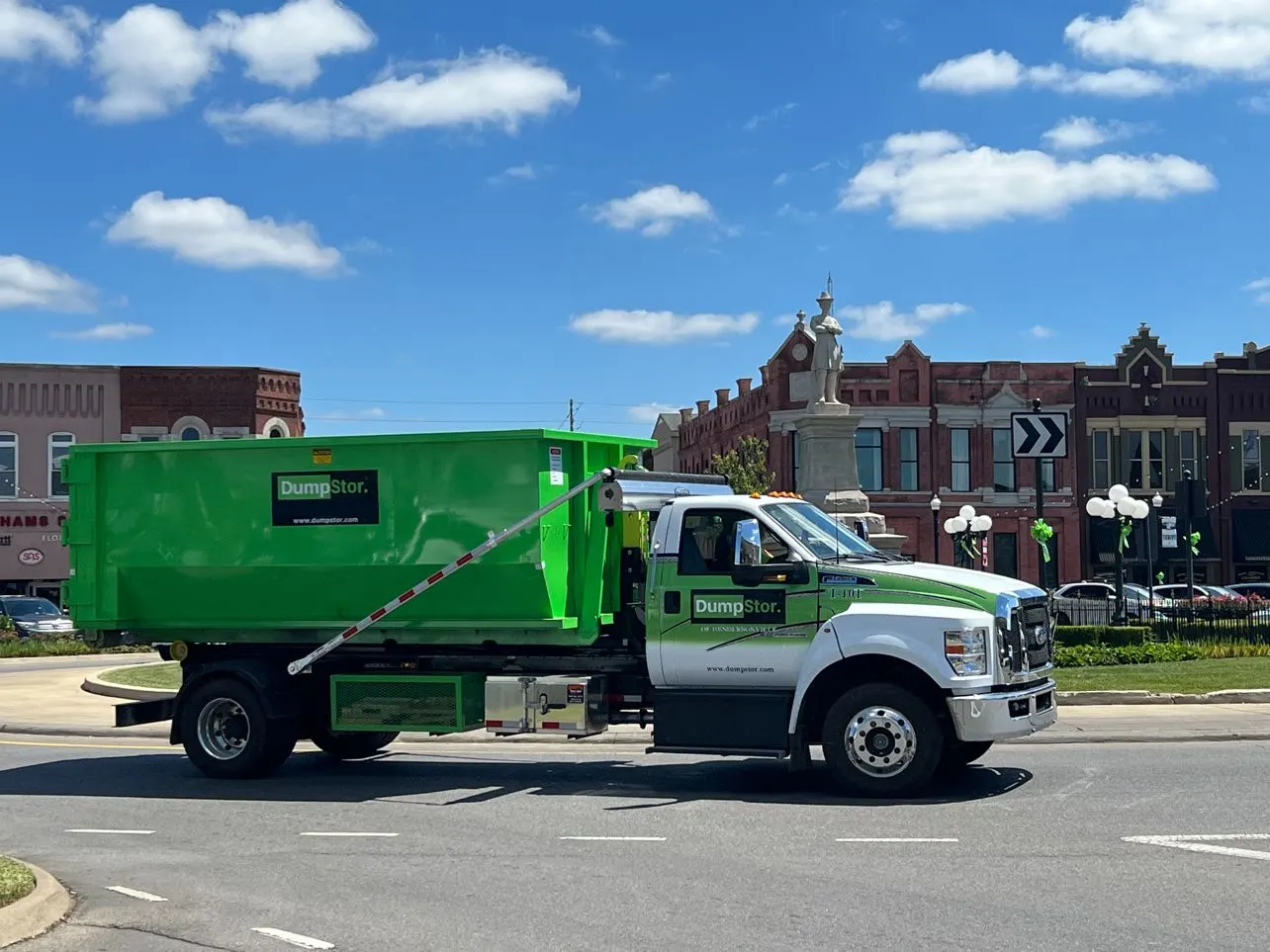 dumpster rental truck in road