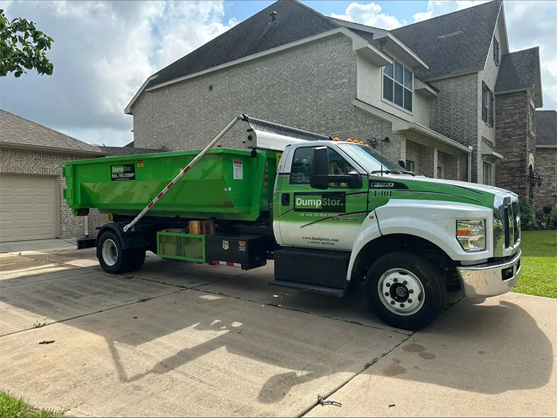 dumpster rental truck in front driveway